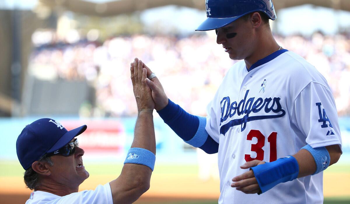 Dodgers Manager Don Mattingly high fives Joc Pederson after Pederson scored in the second inning against the San Francisco Giants on Sunday.