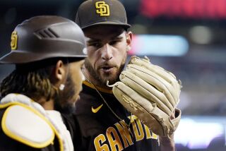 San Diego Padres starting pitcher Joe Musgrove, right, talks with Padres catcher Luis Campusano as both walk off the field after the final out during the third inning of a baseball game against the Arizona Diamondbacks in Phoenix, Saturday, Sept. 17, 2022. (AP Photo/Ross D. Franklin)