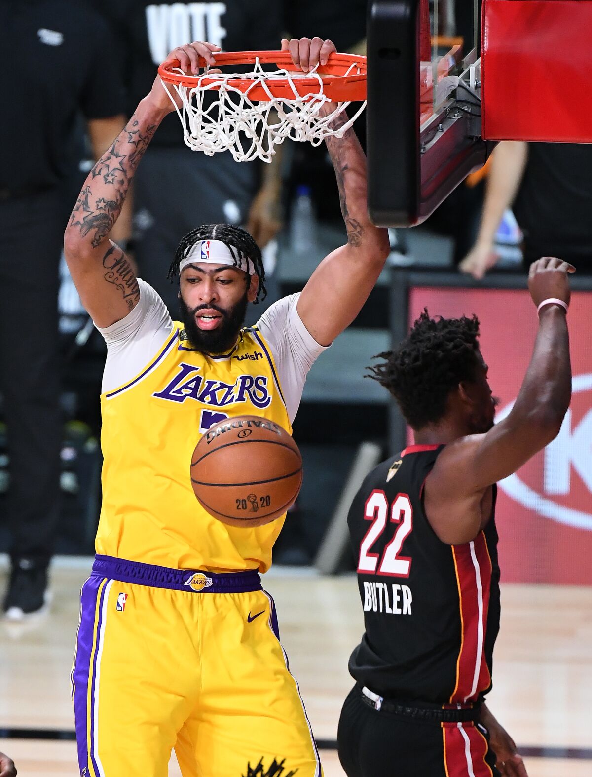 Lakers forward Anthony Davis dunks over Miami's Jimmy Butler during Game 1.