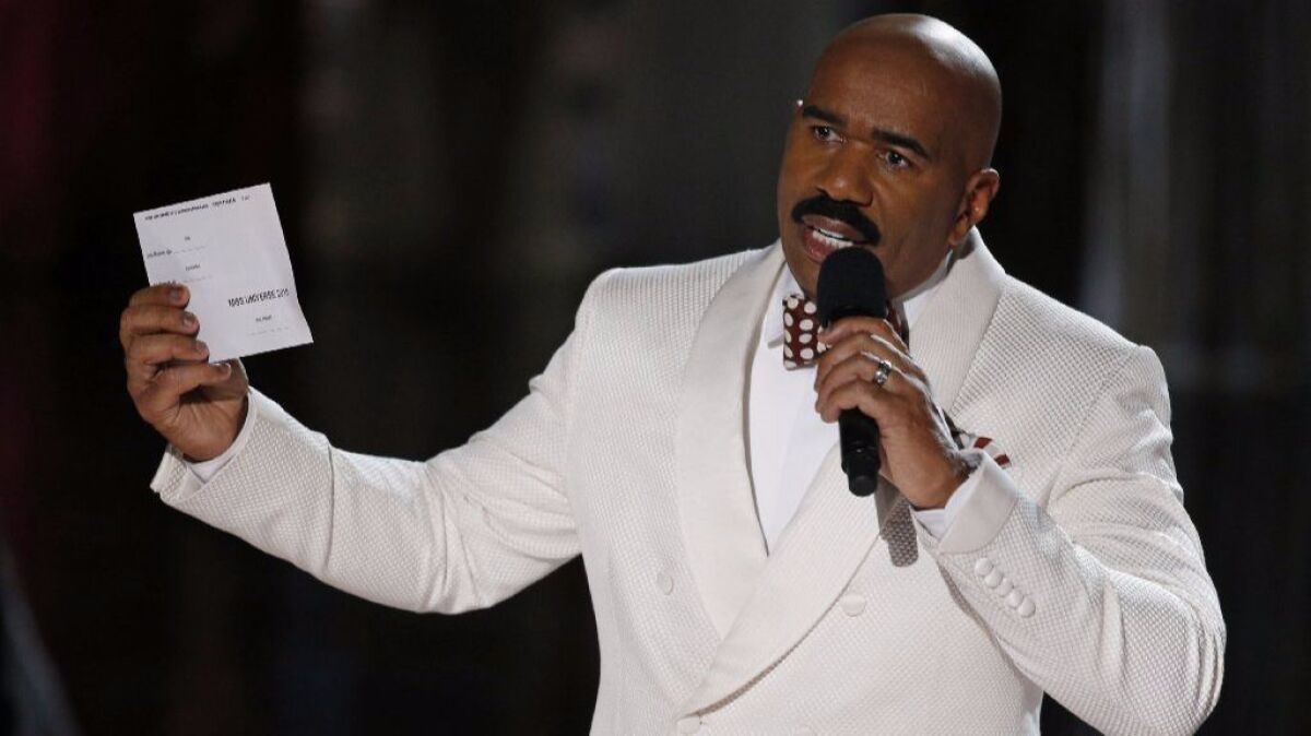 Steve Harvey holds up the card showing the winners after incorrectly announcing Miss Colombia as the winner at the 2015 Miss Universe pageant in Las Vegas. His mistake was quickly corrected, giving the crown to Miss Philippines.