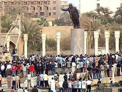 A statue of Saddam Hussein is brought down by Marines as Iraqis watch in Baghdad.