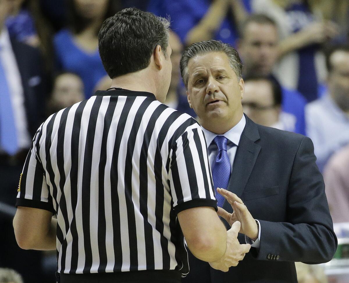 Kentucky Coach John Calipari speaks with an official during the first half of a Southeastern Conference tournament semifinal game against Auburn. The Wildcats went undefeated, 34-0, and are a favorite to win the NCAA tournament.