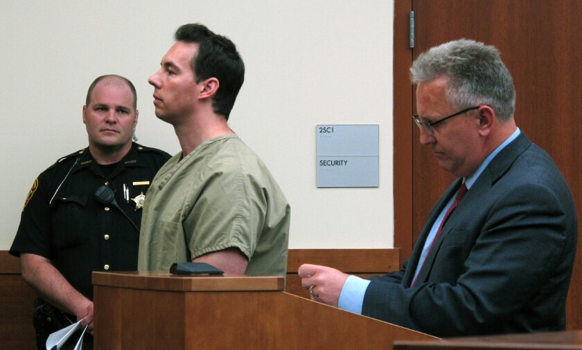 FILE - In this June 5, 2019 file photo former critical care doctor William Husel, center, pleads not guilty to murder charges while appearing with defense attorney Richard Blake, right, in Franklin County Court in Columbus, Ohio. A federal judge has declined for now to compel a Michigan-based health system to advance legal costs for Husel's defense against murder charges in the deaths of 25 Ohio hospital patients. (AP Photo/Kantele Franko, File)