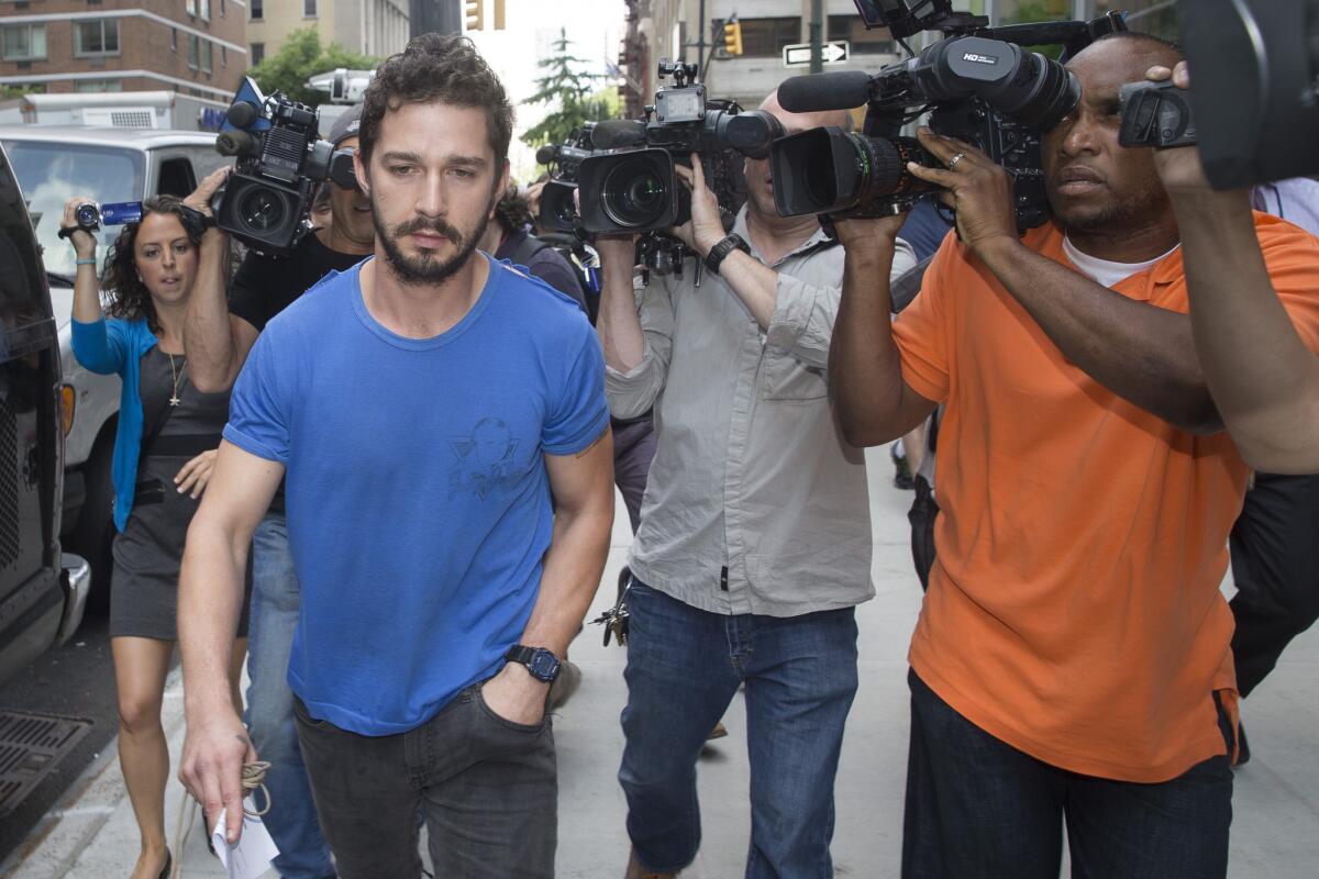 Actor Shia LaBeouf walks through the media after leaving the Midtown Community Court in New York on June 27 following his arrest for disrupting a performance of the musical "Cabaret."