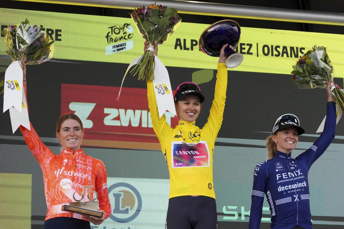 Tour de France women's winner Kasia Niewiadoma is flanked by runner-up Demi Vollering, left, and Pauliena Rooijakker.