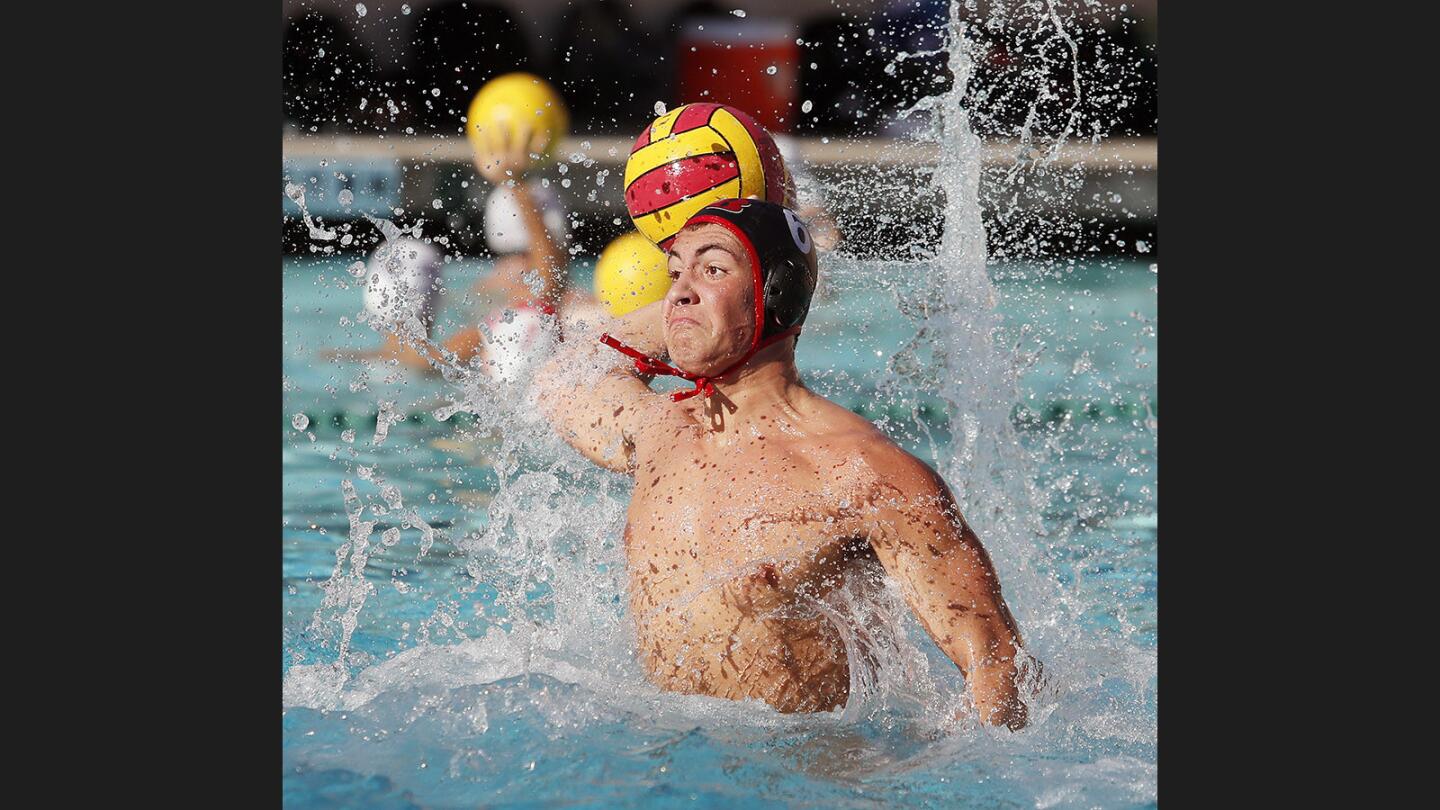 Burroughs' Arthur Sefayan rises high to shoot and score against Hoover in a Pacific League boys' water polo match at Burroughs High School on Thursday, October 5, 2017.