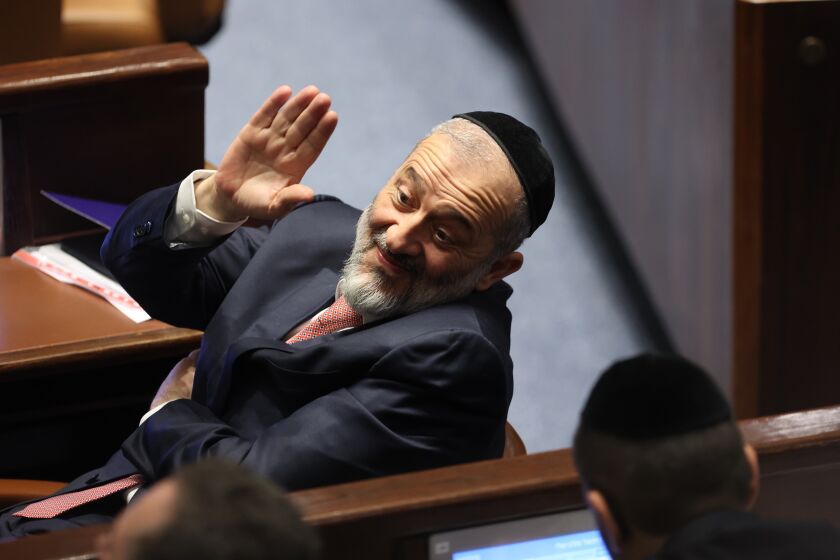 FILE - Member of Knesset Aryeh Deri waves during the swearing-in ceremony for Israeli lawmakers at the Knesset, Israel's parliament, in Jerusalem, Tuesday, Nov. 15, 2022. Designated Prime Minister Benjamin Netanyahu's Likud Party said Thursday, Dec. 8, 2022 it had reached a coalition deal with Shas, granting the ultra-Orthodox party control over several key ministries as it moved closer to forming a new government following Nov. 1 elections.(Abir Sultan/Pool Photo via AP, File)