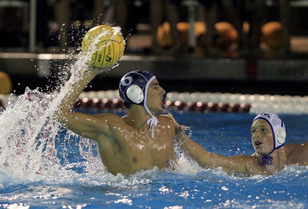 Newport Harbor High's Luca Cupido, left, looks to shoot against Corona del Mar's Ashton Jajonie during the Battle of the Bay game on Saturday. Cupido scored three goals.