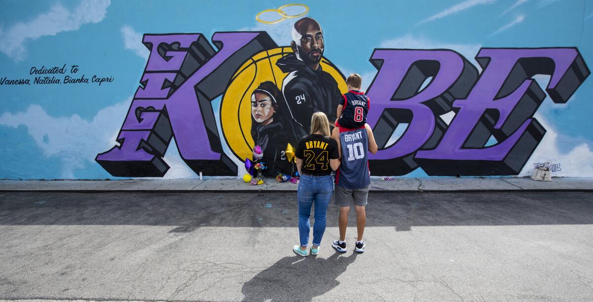 Ryan Broccolo, with wife Megan and son Brayden admire a mural of Kobe Bryant and his daughter, Gianna.