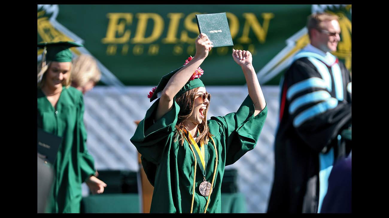 Kylie Asam cheers after receiving her diploma at the Edison High School graduation ceremony, held at Orange Coast College Dick Tucker Field in Costa Mesa on Thursday, June 14, 2018.