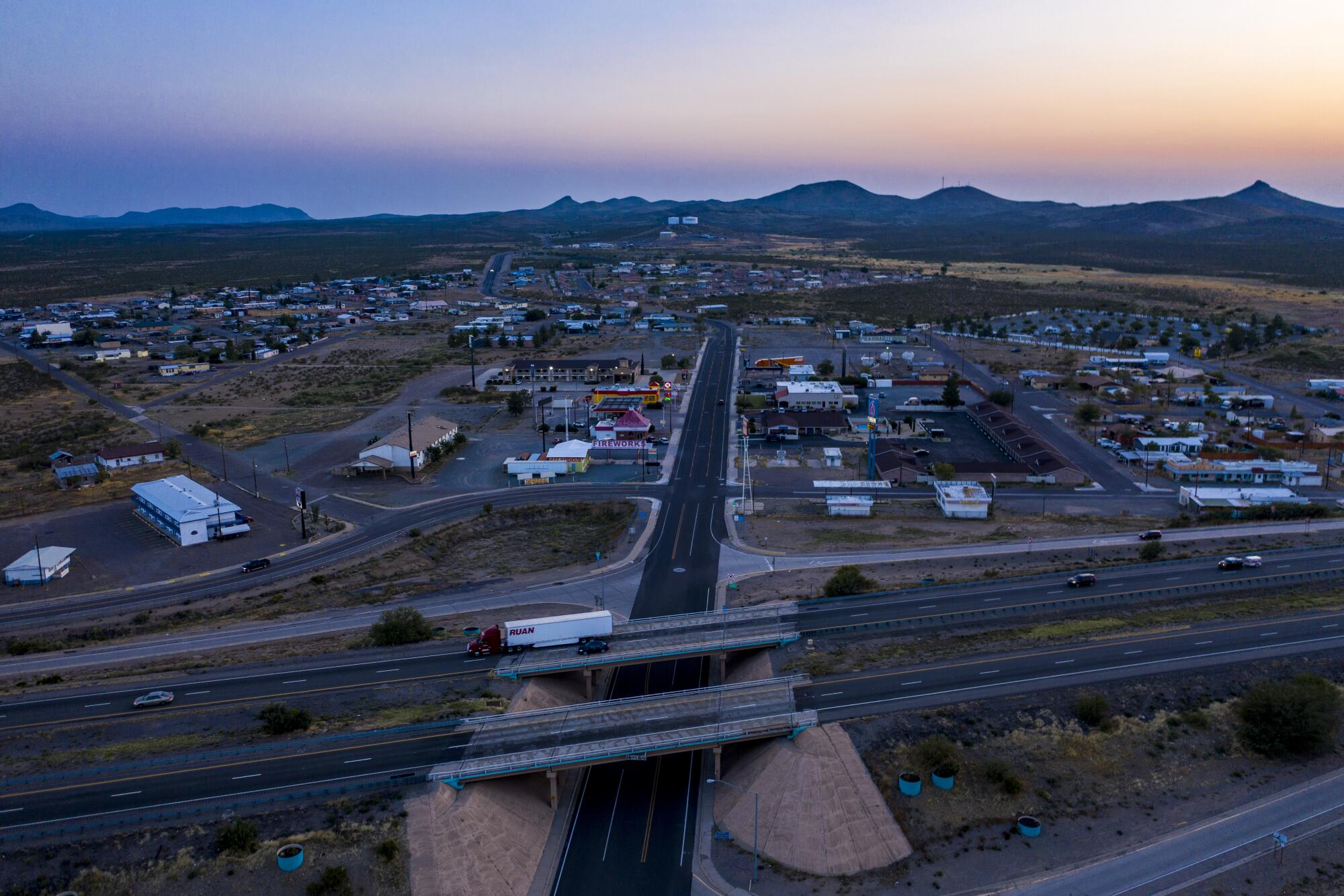 A truck rolls past the Main St. exit on Interstate 10, dividing the rural town of Lordsburg, NM. 