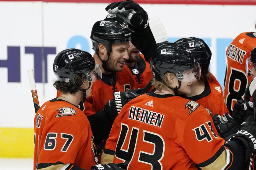 The Ducks' Ryan Getzlaf, back left, is congratulated on his overtime goal at Colorado by Sam Steel, back right.