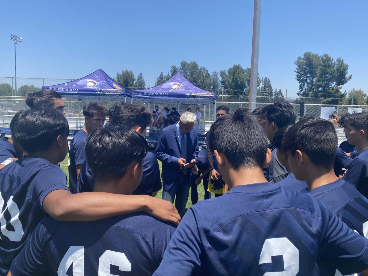 Birmingham soccer coach EB Madha addresses his team before its 4-2 win over Clovis.