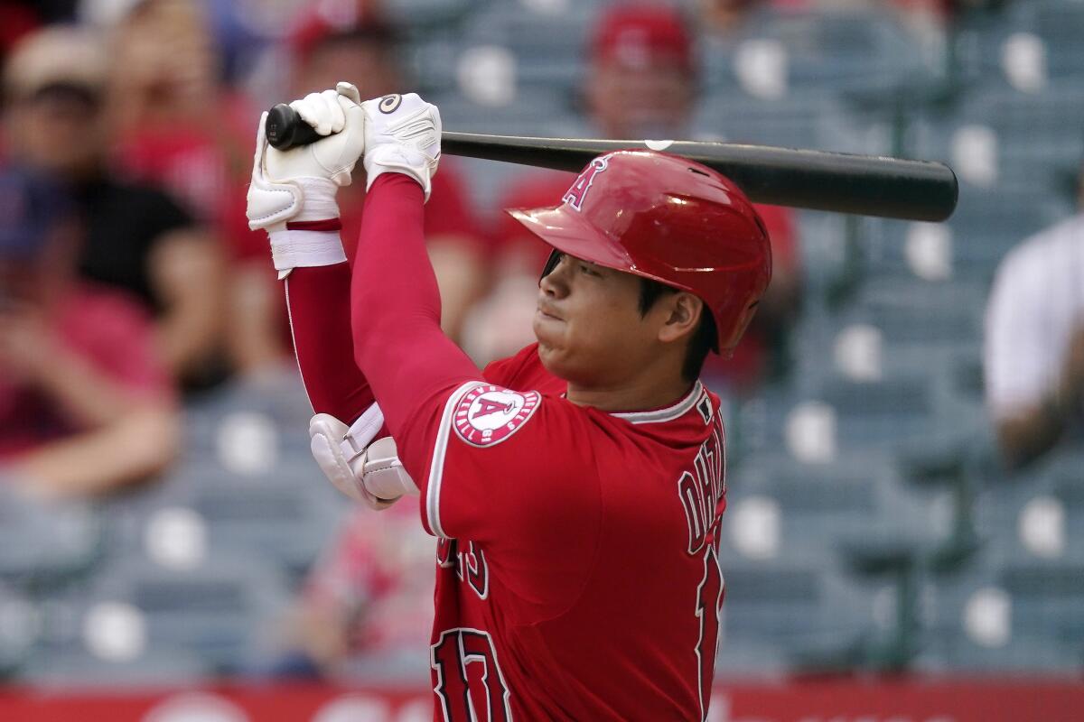 Shohei Ohtani triples during the first inning against the Texas Rangers on Sunday.