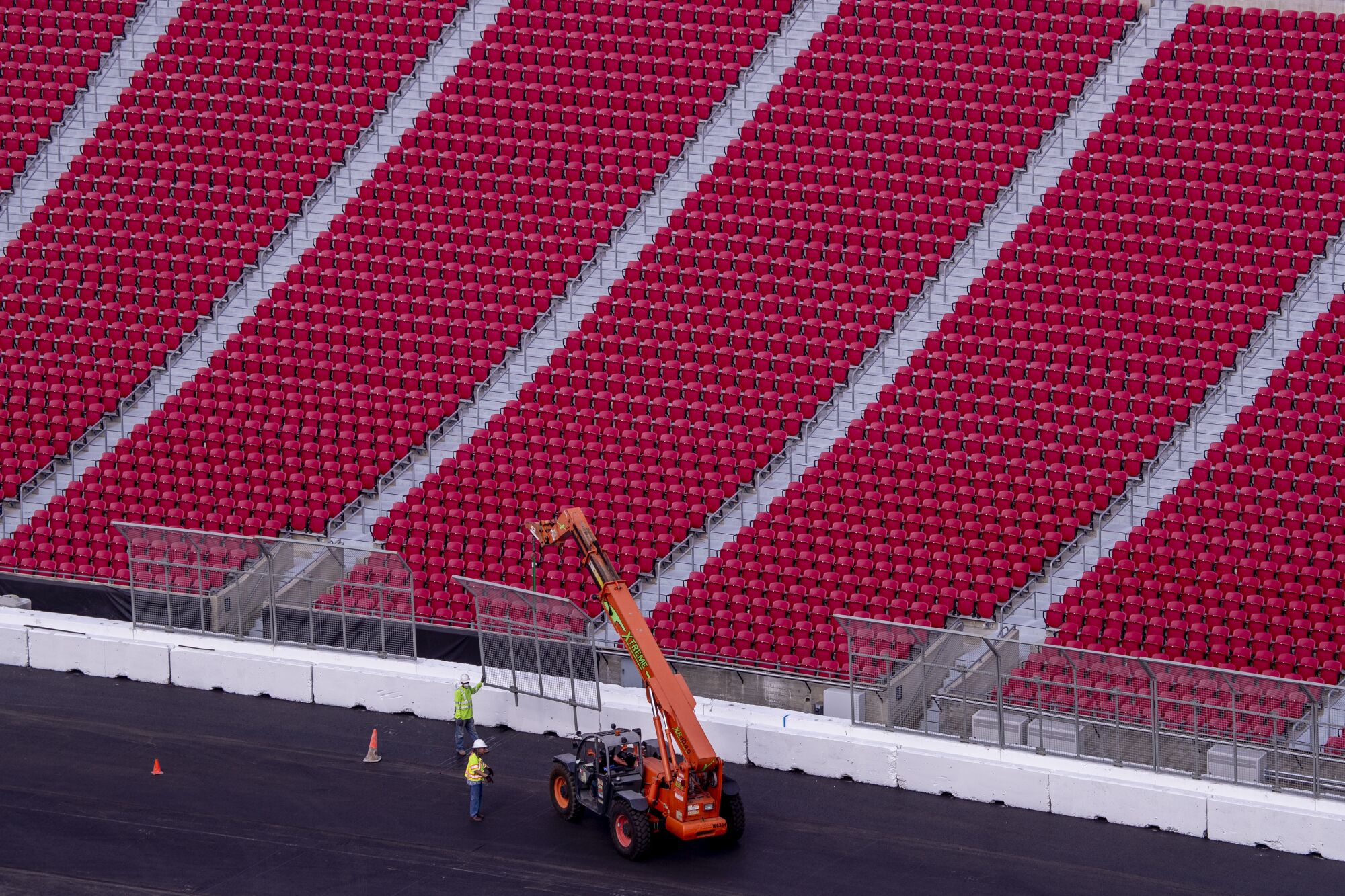 Construction crews transform the Coliseum from a football stadium to a quarter-mile short track NASCAR exhibition race track.