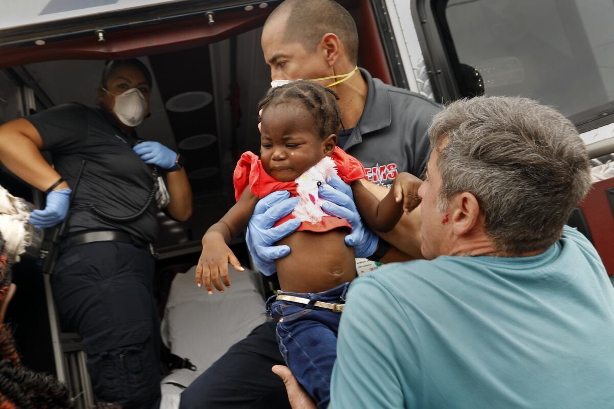 A sick migrant child is taken to the hospital after she and her mother were released from detention in Del Rio, Texas, last week.