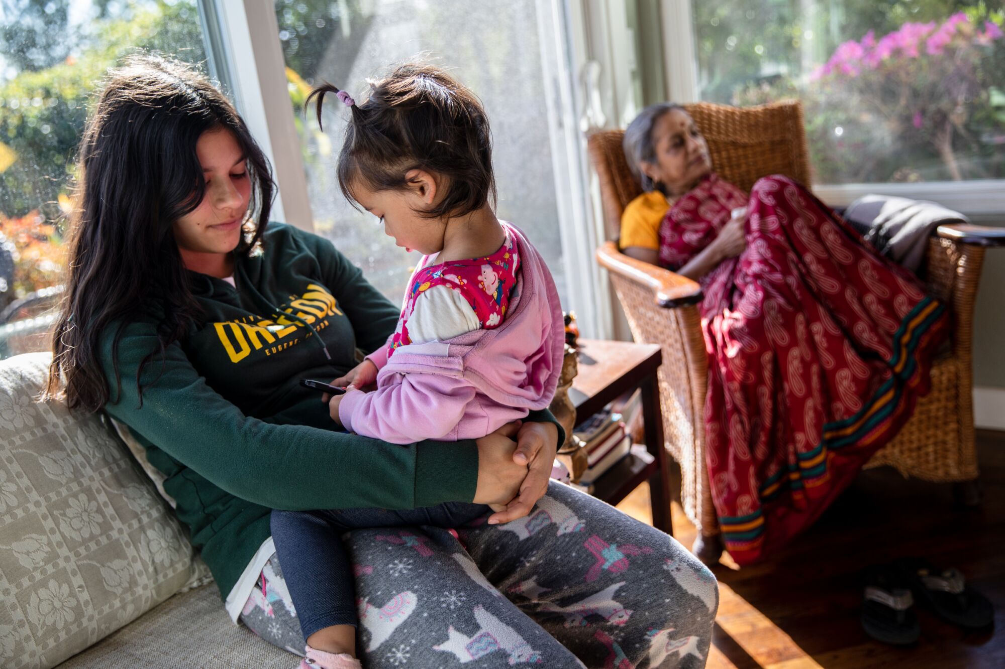Vishaala Wilkinson holds her 2-year-old sister Lalitha at their home in Del Mar on March 2, 2021.