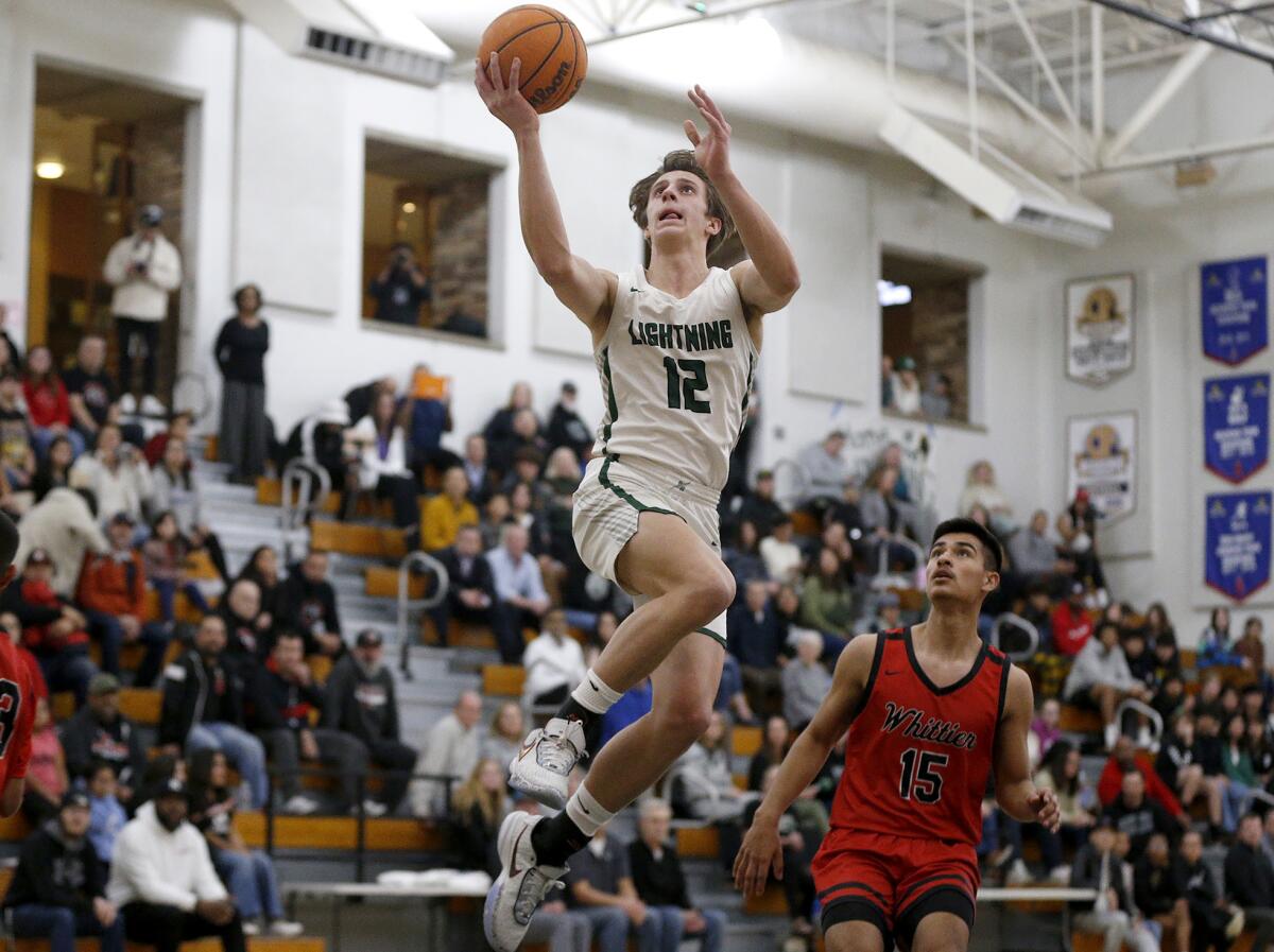 Sage Hill's Gage Talleur (12) converts a layup on a fastbreak against Whittier on Wednesday.