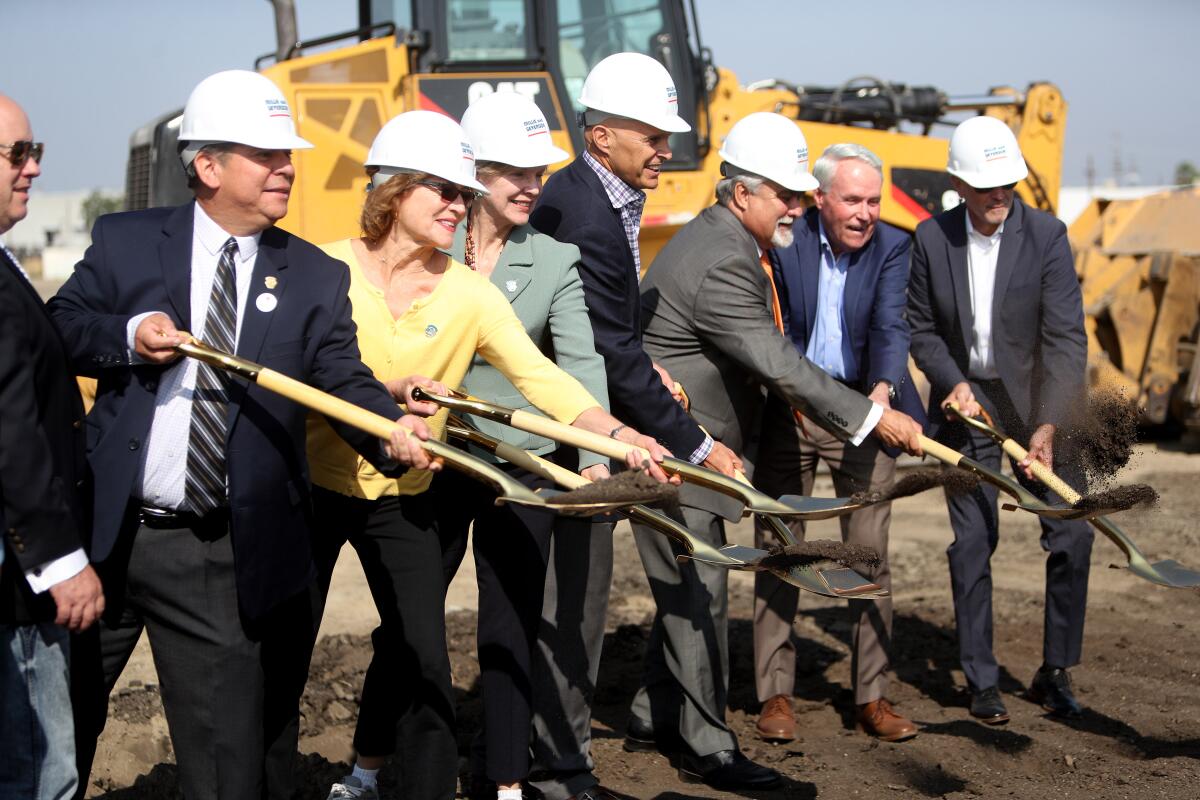 City and project officials ceremoniously throw dirt at the Avion Burbank project, a mixed-use creative industrial park north of the Hollywood Burbank Airport, that is planned to have 18 buildings during a groundbreaking ceremony by Overton Moore Properties in Burbank on Wednesday, Oct. 9, 2019.
