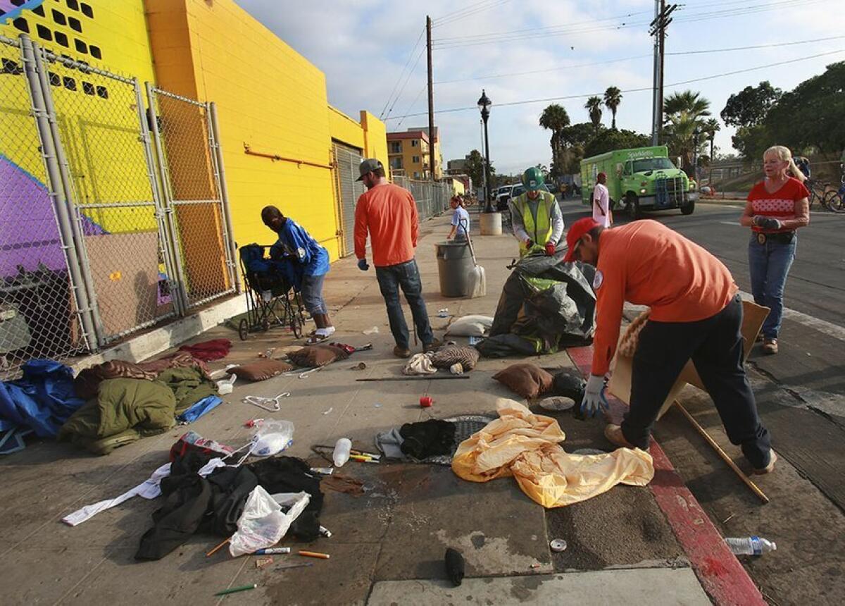 City Environmental Services Department workers clean up along 17th Street in San Diego.