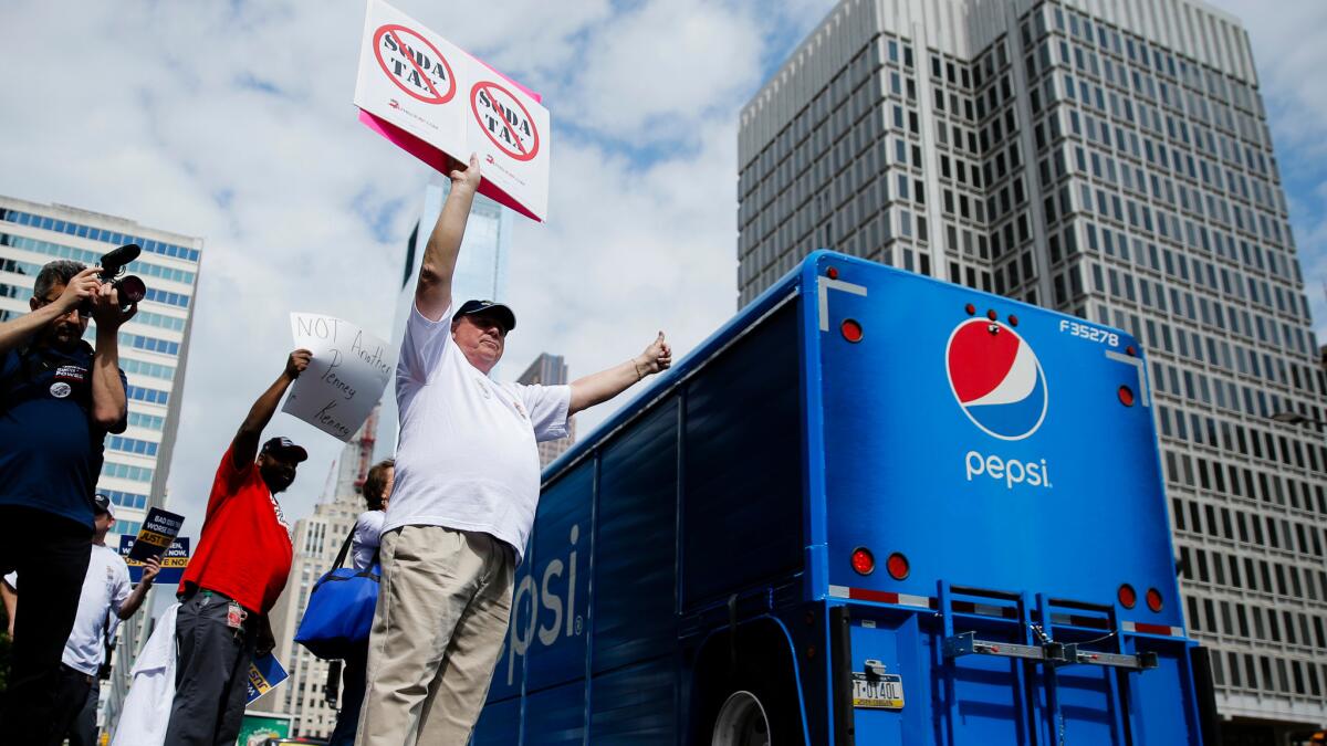 Opponents of a proposed soda tax demonstrate outside City Hall in Philadelphia on June 8.