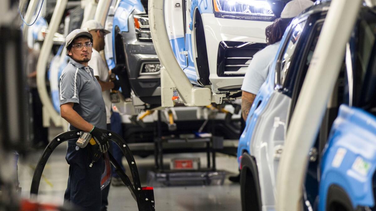 Workers produce vehicles at Volkswagen's plant in Chattanooga, Tenn., on Aug. 31.