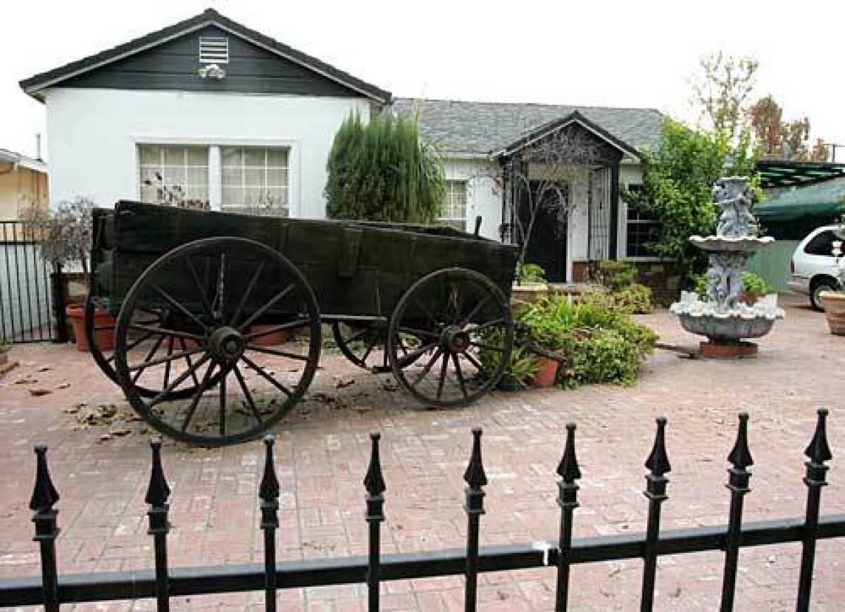 An old wagon is part of the décor in the frontyard of a home in the horse-friendly area of Burbank.