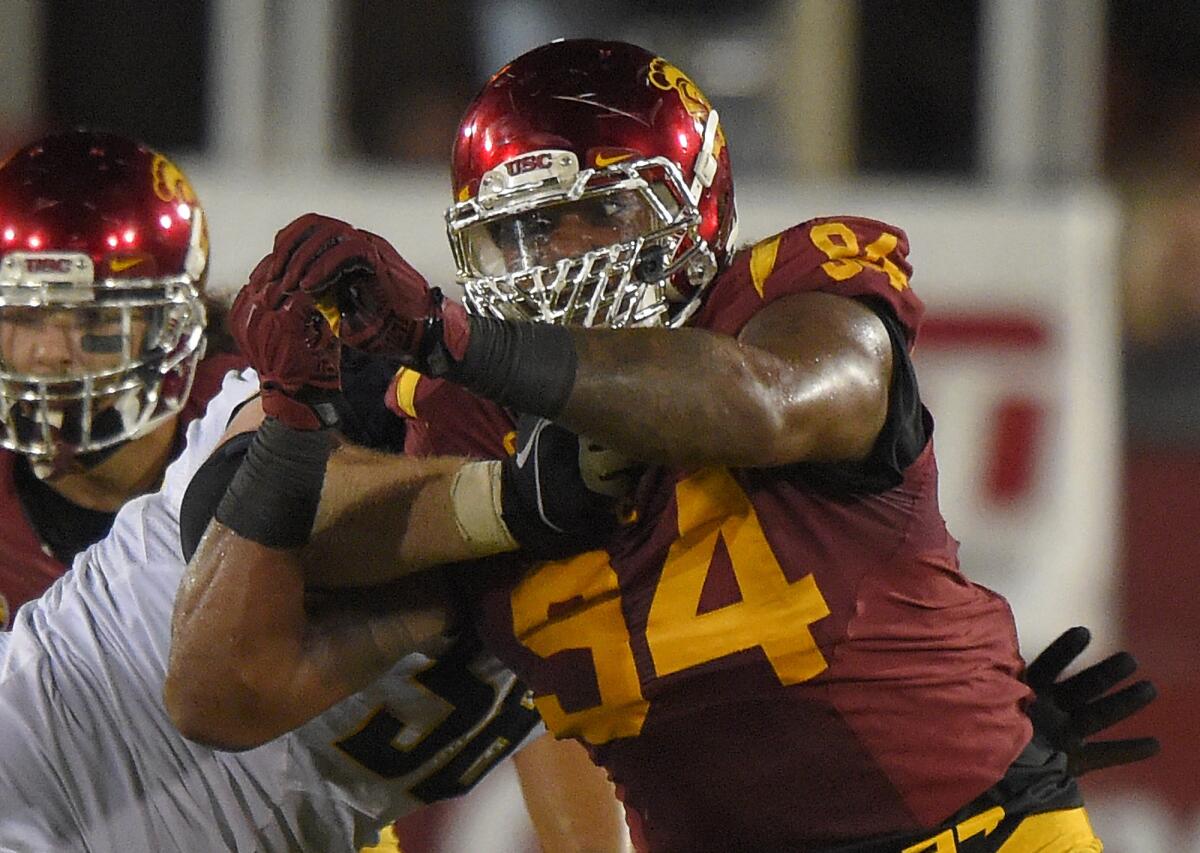 USC defensive end Leonard Williams, right, works on California offensive lineman Chris Adcock at the Coliseum on Nov. 13.