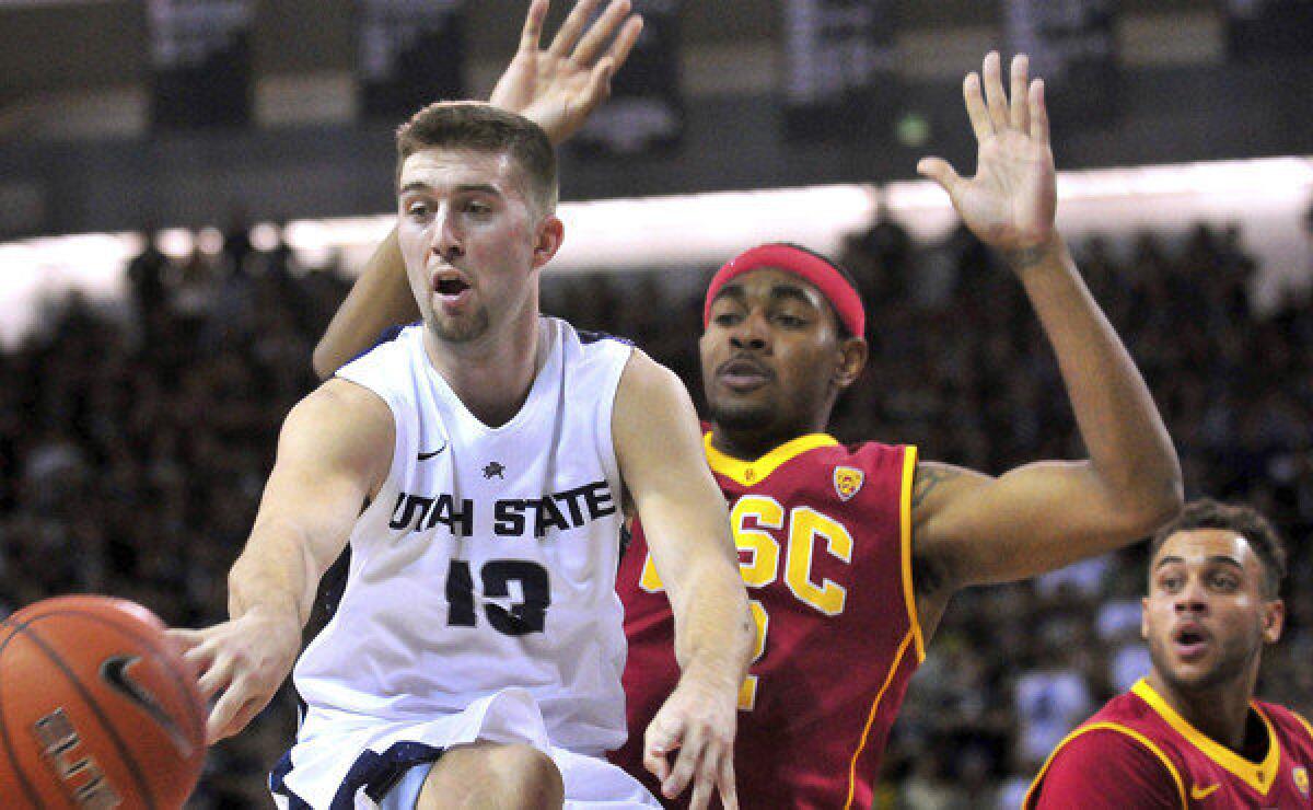 Utah State's Preston Medlin makes a pass in front of USC's Roschon Prince during the Trojans' 78-65 season-opening loss Friday.