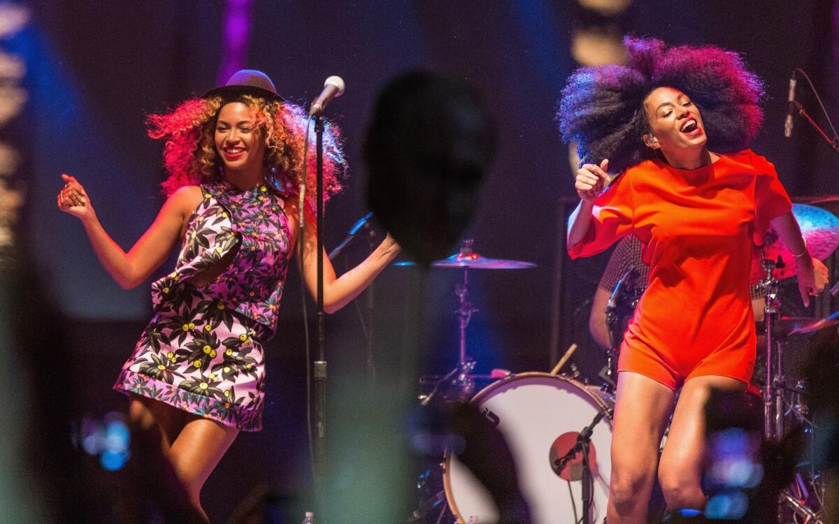 Beyonce, left, performs with her sister Solange Knowles during Day 2 of the 2014 Coachella Valley Music & Arts Festival at the Empire Polo Club in Indio, Calif.