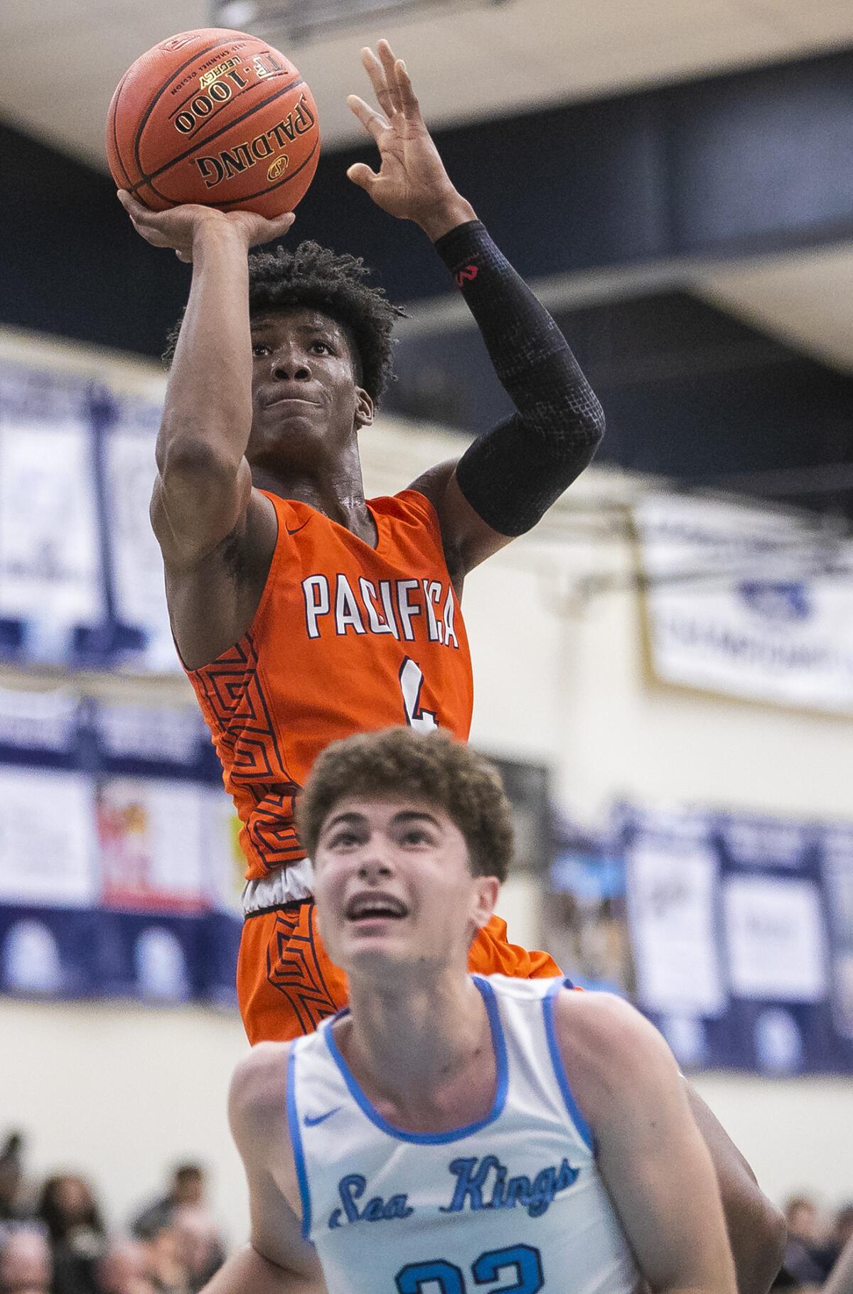 Pacifica Christian Orange County's Charles Erving takes a shot over Corona del Mar's Efe Gucoglu in a pool-play game of the CdM Beach Bash on Thursday.