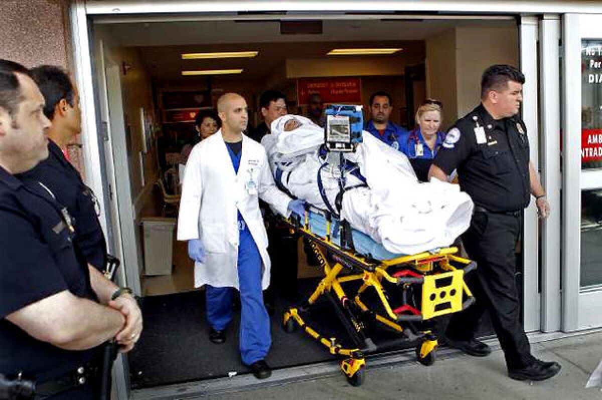 Bryan Stow, the Giants fan who was beaten at Dodger Stadium, is wheeled out of L.A. County-USC Medical Center.