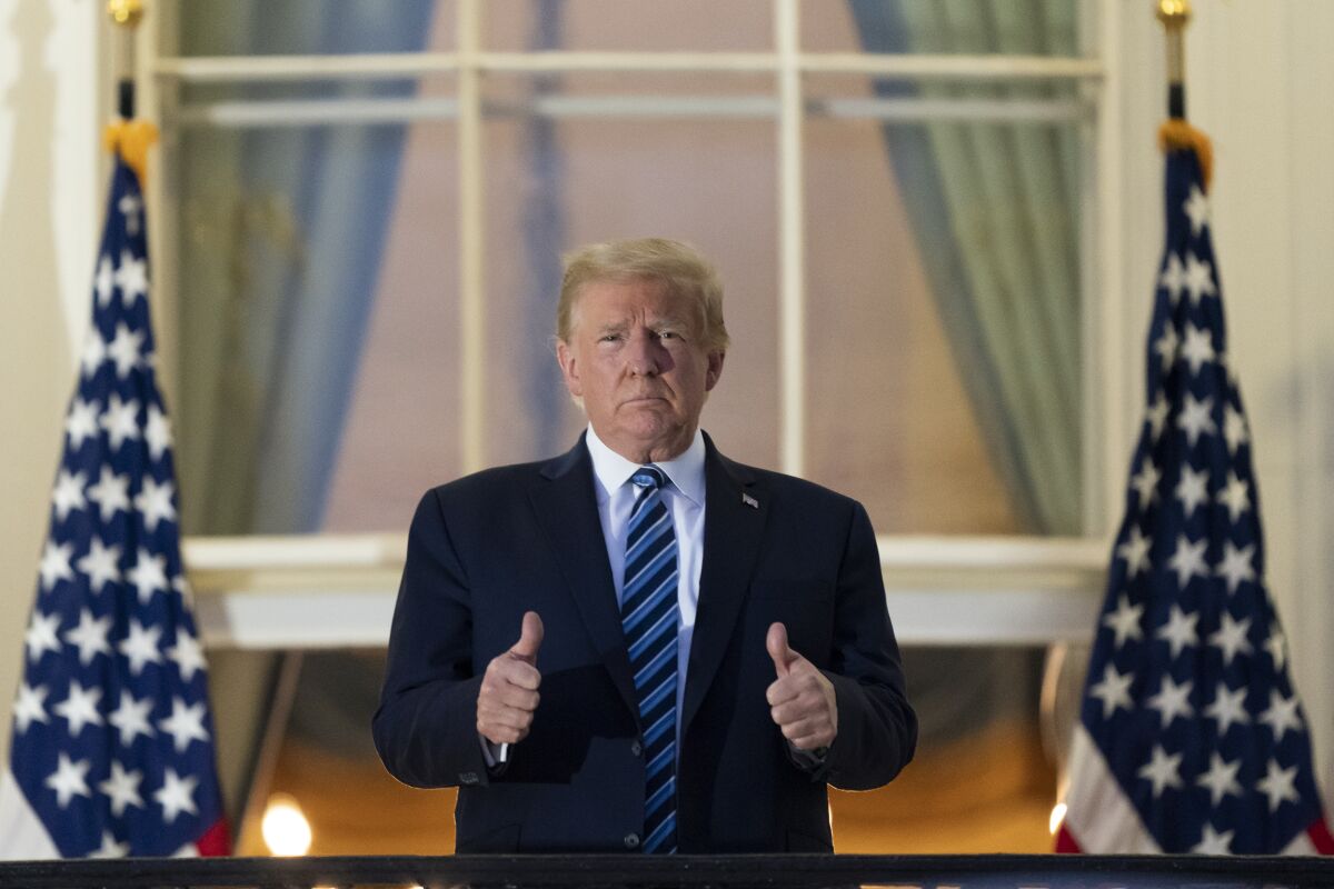 President Trump gives two thumbs up on the Blue Room Balcony 