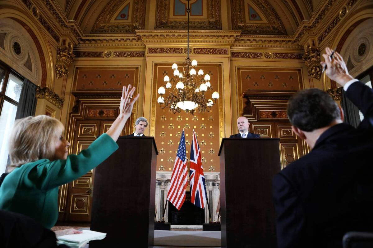 Reporters ask questions as U.S. Secretary of State John F. Kerry, rear left, and British Foreign Secretary William Hague hold a news conference at the Foreign and Commonwealth Office in London.