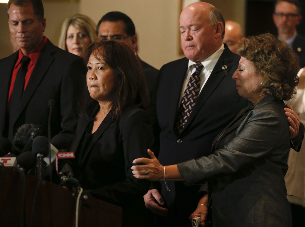 Trudy Raymundo, director the the San Bernardino County Department of Public Health, is surrounded by San Bernardino County supervisors as she addresses the media during a press conference Monday.