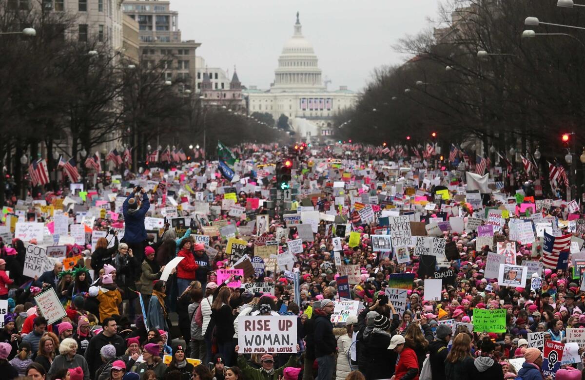 Protesters walk during the Women's March on Washington, with the U.S. Capitol in the background, on Jan. 21, 2017, in Washington, D.C.