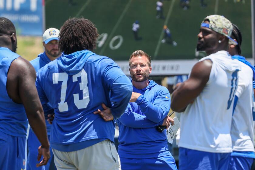 Rams coach Sean McVay talks with center Steve Avila (73) during OTA practice at Cal Lutheran University.