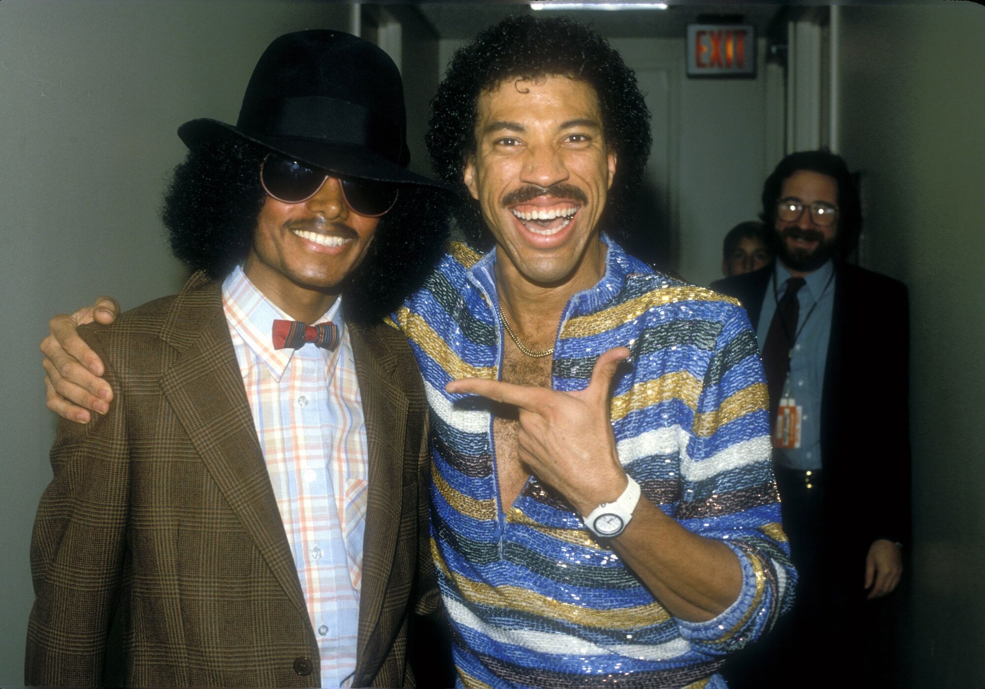 Michael Jackson, left, in a bowtie and bowler hat, and Lionel Richie in a sequened striped shirt 