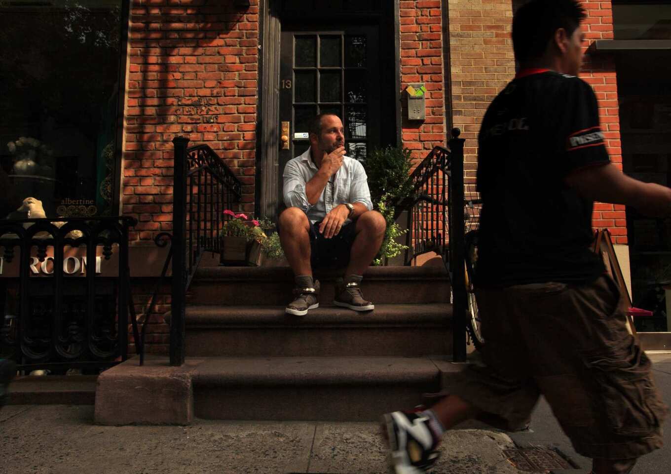 Scott Elyanow, who lives in a 275-square-foot apartment in New York's West Village, spends a lot of time on the front stoop people-watching.