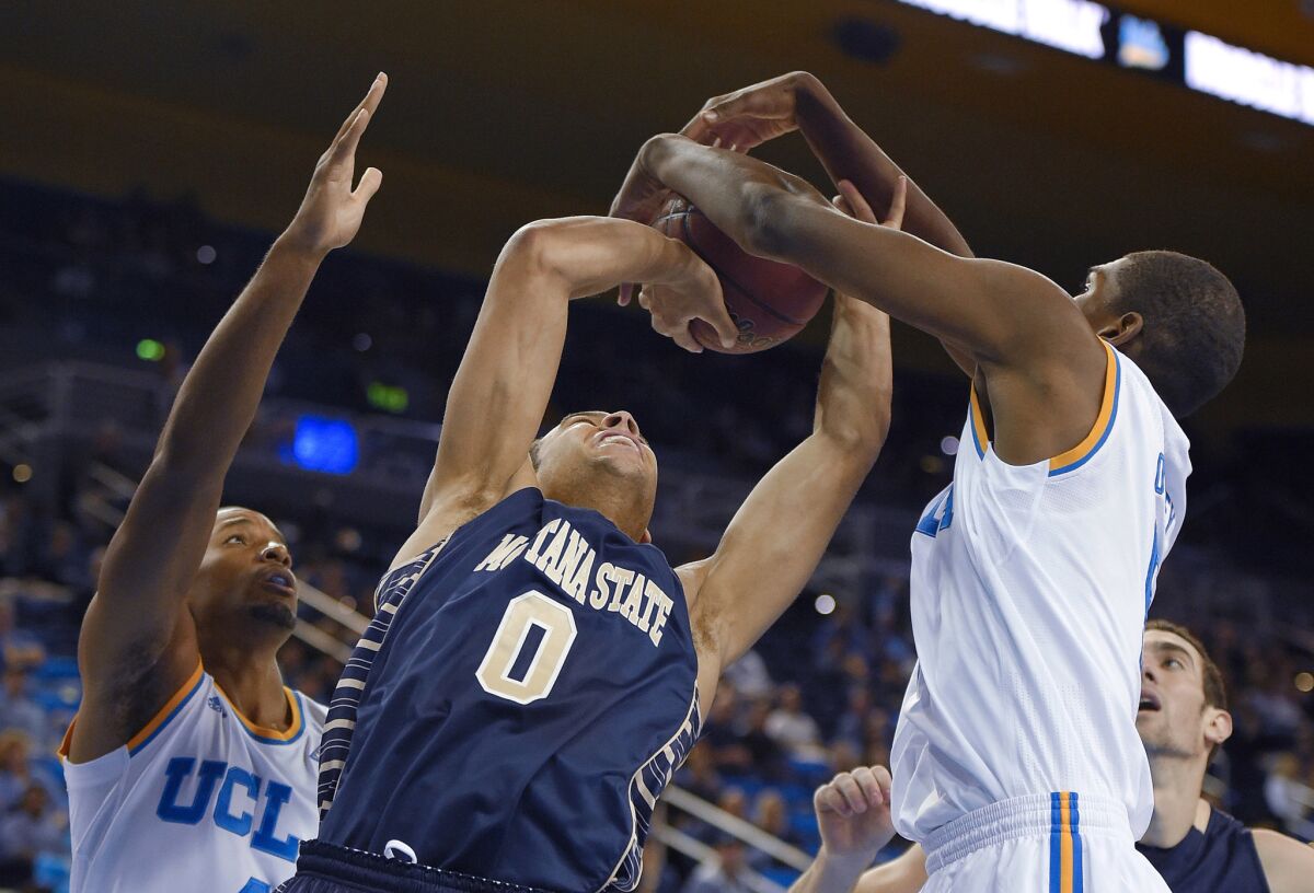 UCLA forward Kevon Looney, right, blocks the shot of Montana State guard Zach Green, center, during the Bruins' 113-78 win over the Bobcats on Nov. 14.