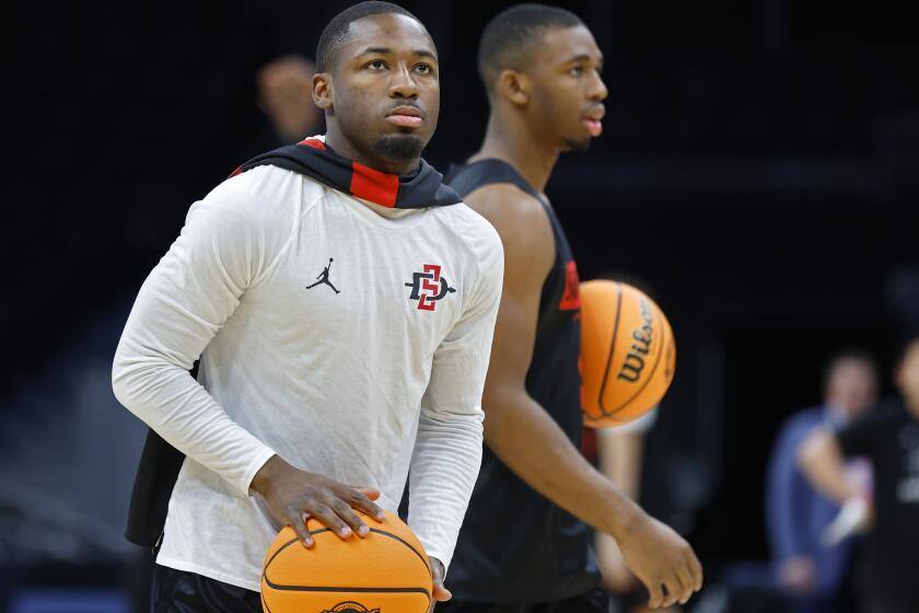 Boston, MA- March 27: San Diego State's Darrion Trammell and Lamont Butler practice for a Sweet 16 game against UConn at the TD Garden on Wednesday, March 27, 2024 in Boston, MA. (K.C. Alfred / The San Diego Union-Tribune)