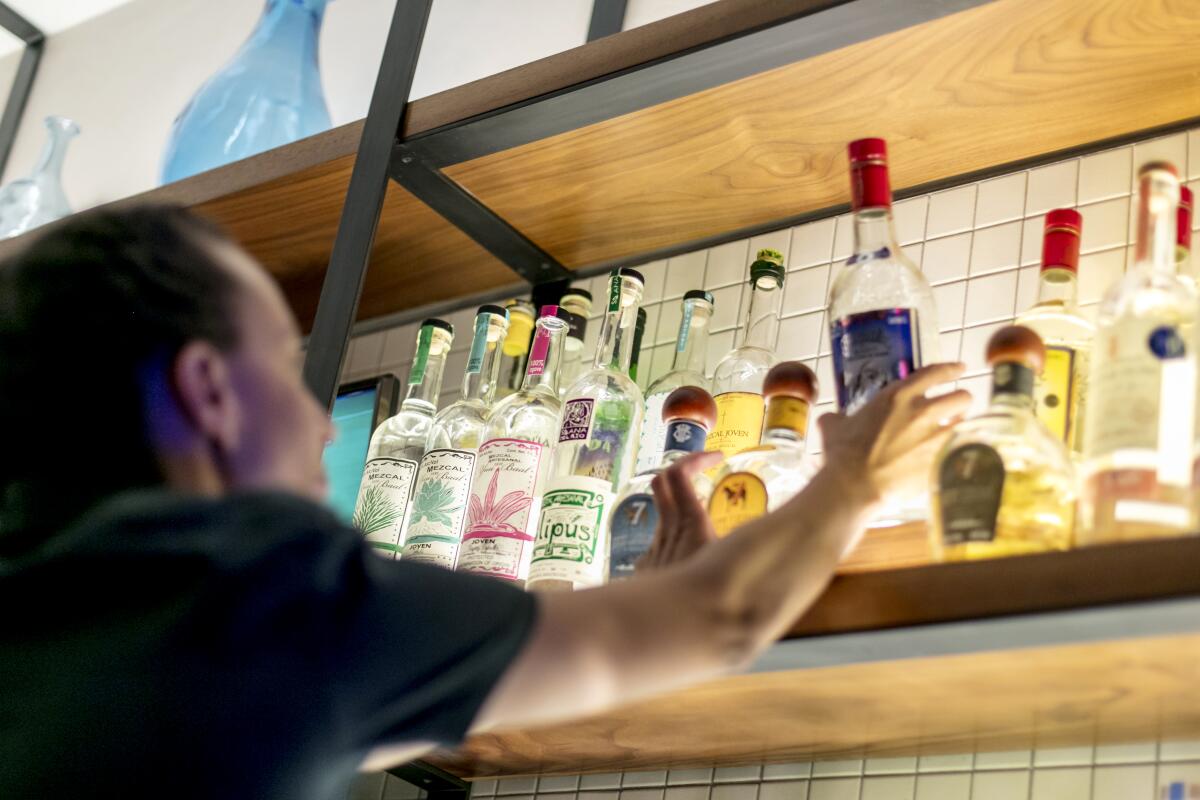 A bartender works the bar at Pikoh on a Friday evening.