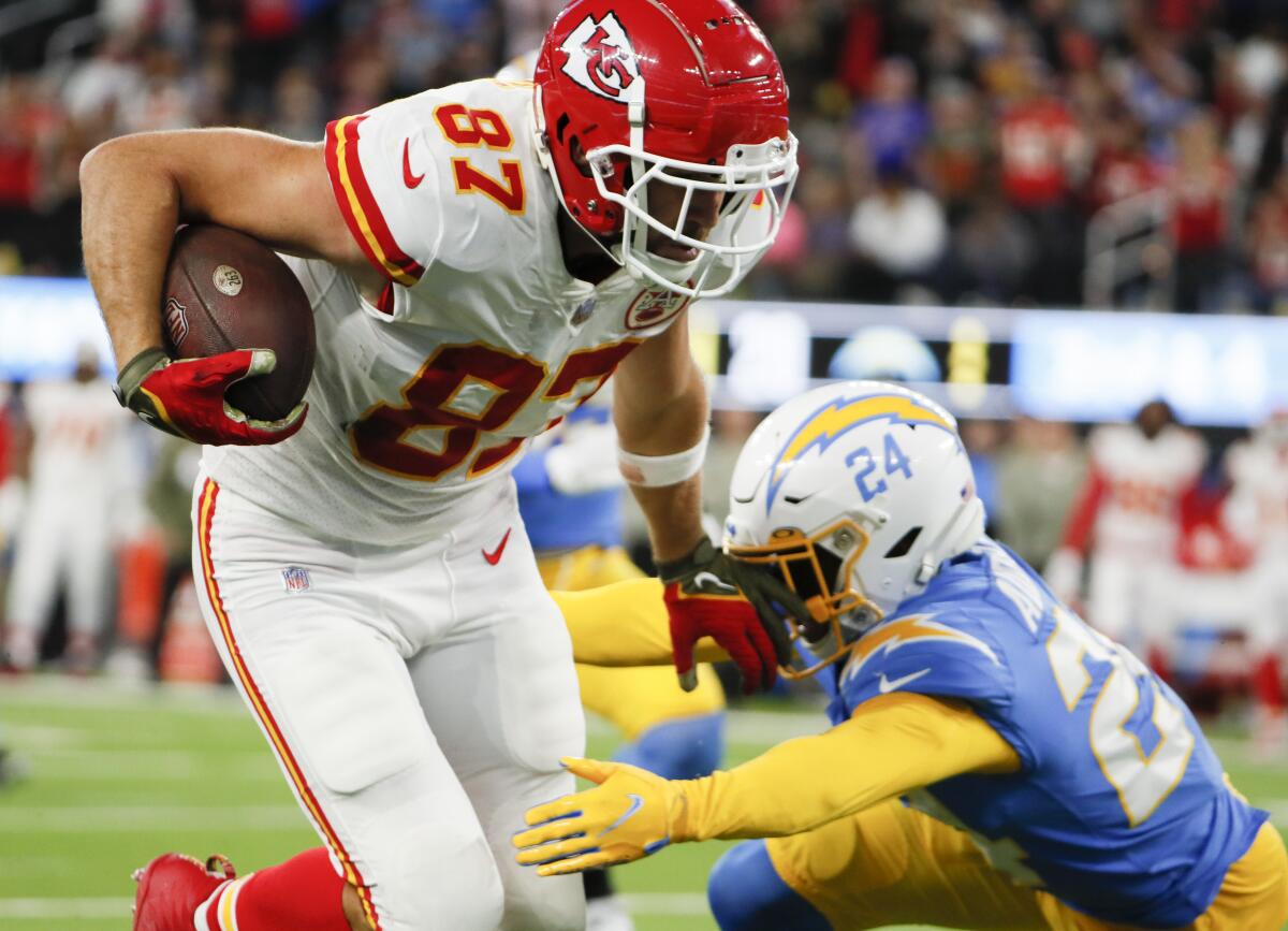 Chiefs tight end Travis Kelce (87) runs past Chargers safety Nasir Adderley (24) on a catch for a touchdown.