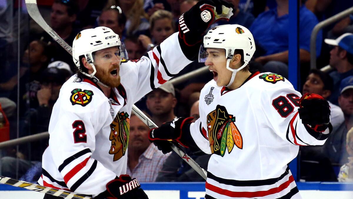 Blackhawks center Teuvo Teravainen (86) celebrates with defenseman Duncan Keith (2) after scoring against the Lightning in the third period of Game 1 of the Stanley Cup Final on Wednesday.