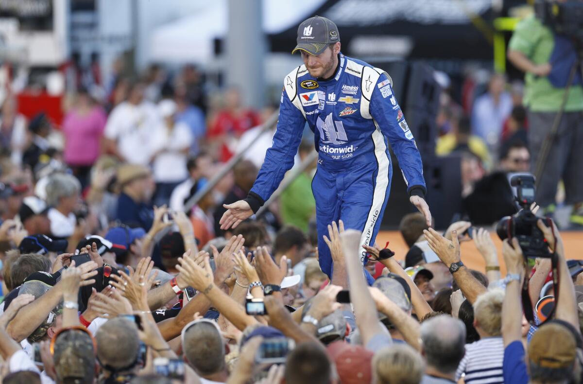 Dale Earnhardt Jr. greets fans during driver introductions for the NASCAR Sprint Cup race at Richmond International Raceway on Sept. 6.