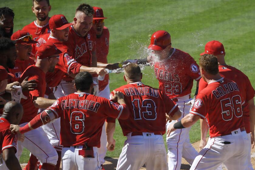 Los Angeles Angels' Matt Thaiss is hit in the face with liquid after hitting a walk-off home run during the ninth inning of a baseball game against the Baltimore Orioles Sunday, July 28, 2019, in Anaheim, Calif. (AP Photo/Mark J. Terrill)