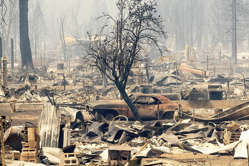 Charred homes and cars in Greeneville, Calif., after the Dixie fire passed through the area Thursday.
