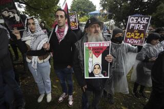 Protesters participate in a sit-in demanding a cease-fire in the Israel-Hamas war at De Longpre Park in Los Angeles on Wednesday, Nov. 15, 2023. Thousands of American Jews and allies, including rabbis and celebrities, gathered in Hollywood to demand an immediate cease-fire in Gaza and an end to U.S. military aid to Israel. (AP Photo/Damian Dovarganes)