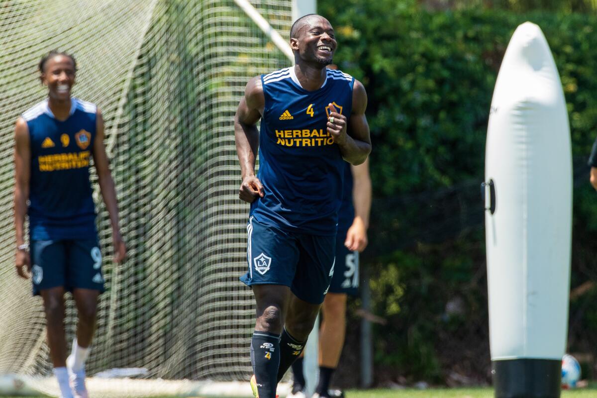 Séga Coulibaly laughs as he runs onto the Galaxy training pitch.