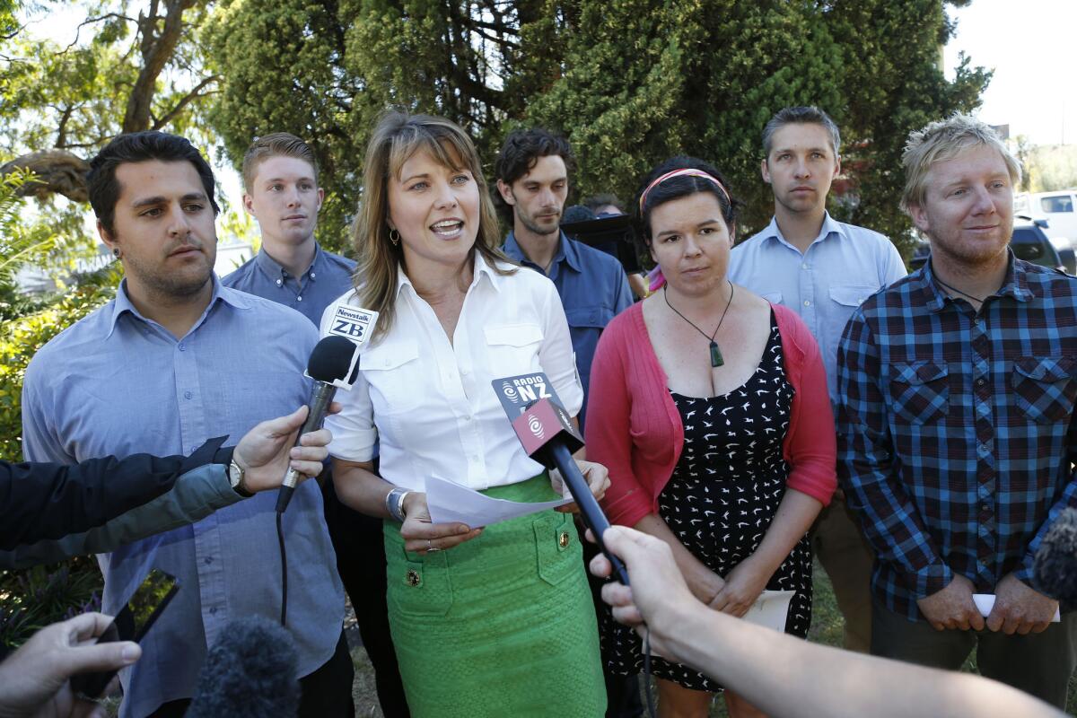 Lucy Lawless, in the green skirt, speaks to the media after appearing in court for sentencing on Thursday in New Zealand.